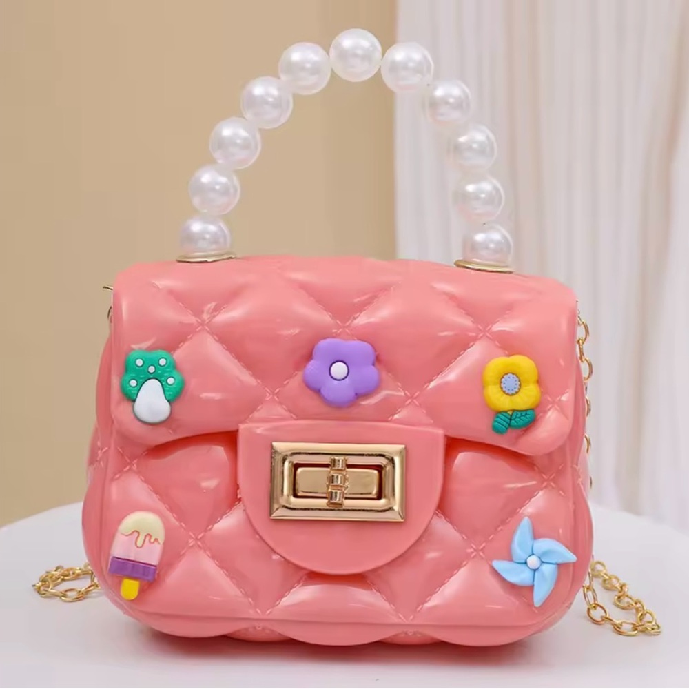 Pink Quilted Handbag with Pearl Handle and a Gold Plated Shoulder Strap.